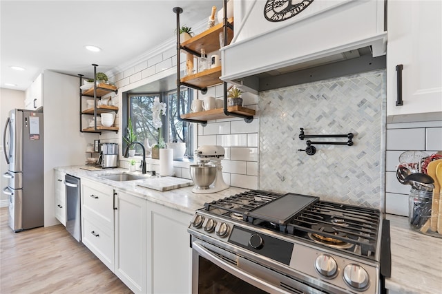 kitchen featuring open shelves, backsplash, a sink, appliances with stainless steel finishes, and custom exhaust hood