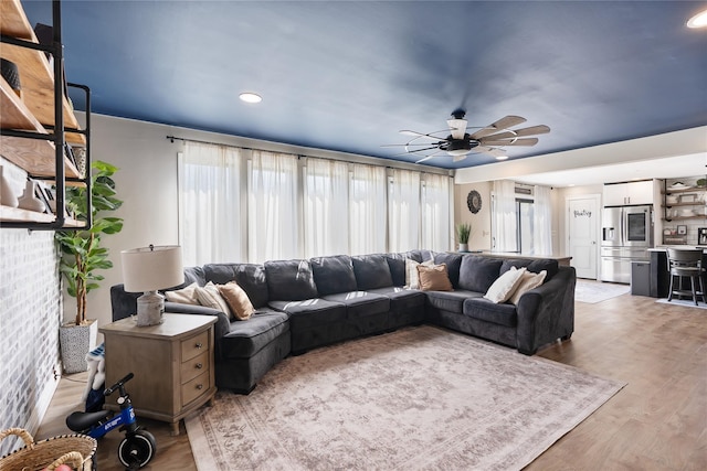 living area featuring recessed lighting, plenty of natural light, light wood-type flooring, and ceiling fan