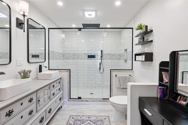 full bathroom with recessed lighting, marble finish floor, a stall shower, and a sink