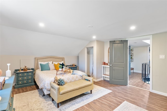 bedroom featuring baseboards, vaulted ceiling, wood finished floors, and recessed lighting