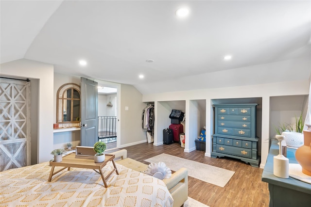 living area featuring lofted ceiling, baseboards, wood finished floors, and recessed lighting