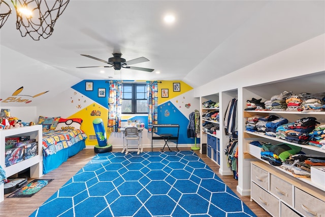 bedroom with vaulted ceiling, ceiling fan, baseboards, and wood finished floors