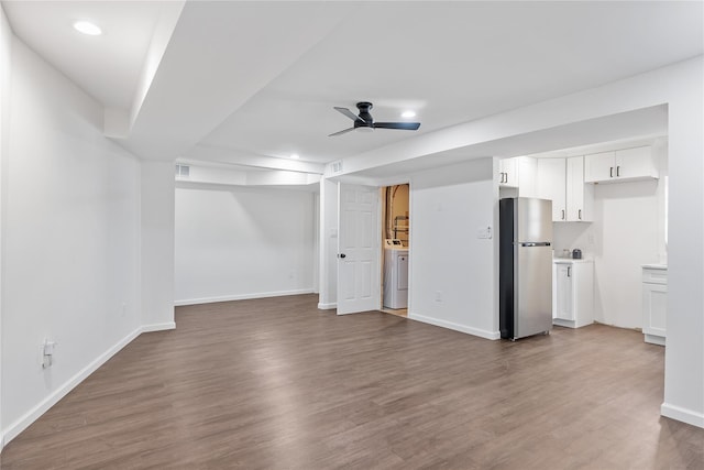 unfurnished living room featuring baseboards, recessed lighting, wood finished floors, ceiling fan, and washer / dryer