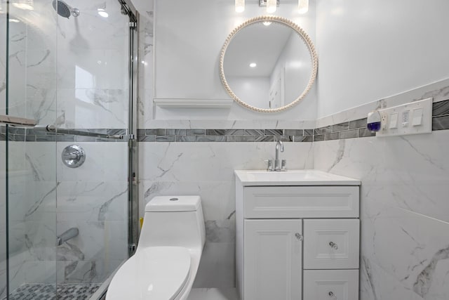 bathroom featuring toilet, tile walls, a stall shower, and vanity