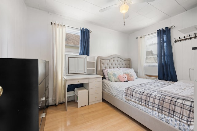 bedroom with light wood finished floors and a ceiling fan