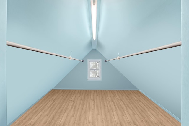 walk in closet with vaulted ceiling with beams and wood finished floors