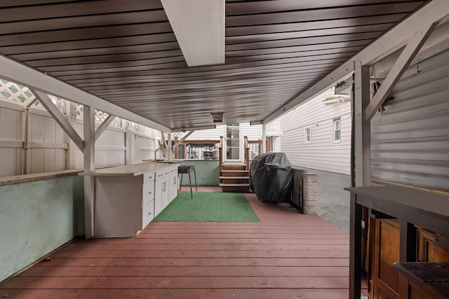 wooden terrace featuring a grill