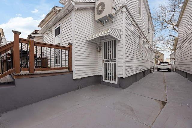 view of property exterior featuring ac unit and a patio
