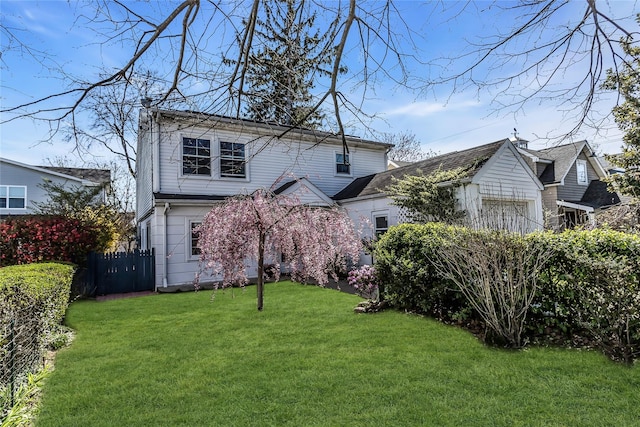 46 Sagamore Hill Dr, Port Washington, NY 11050 - view of front facade with a front lawn and fence