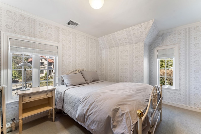 carpeted bedroom with visible vents and ornamental molding