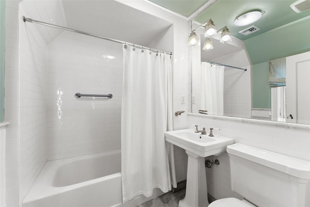 bathroom featuring toilet, visible vents, and shower / tub combo with curtain