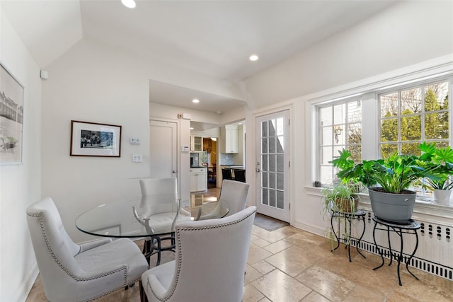 dining area featuring baseboards, radiator heating unit, recessed lighting, and stone tile flooring