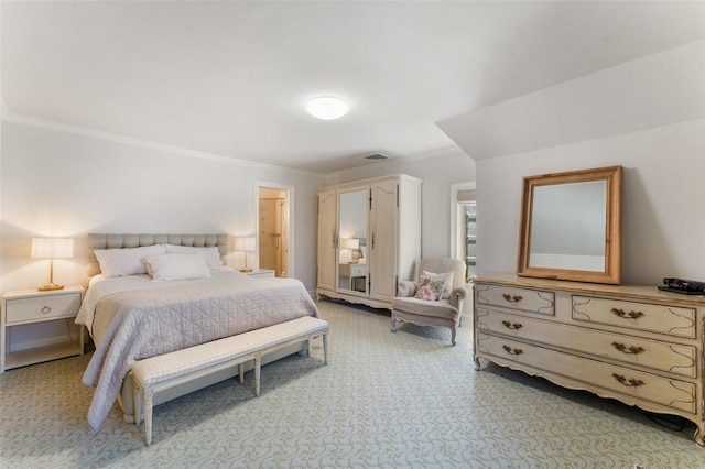 bedroom featuring visible vents, crown molding, and light colored carpet