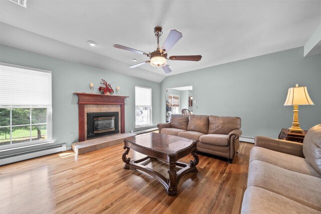 7 Center Cir, Florida, NY 10921 - living room featuring a tile fireplace, a baseboard radiator, a ceiling fan, and wood finished floors