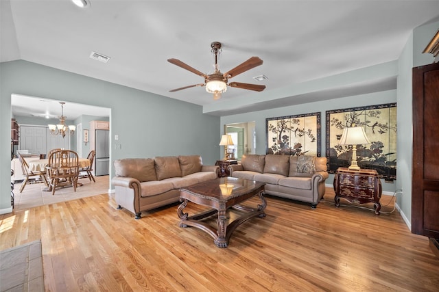 7 Center Cir, Florida, NY 10921 - living room with lofted ceiling, light wood finished floors, visible vents, and ceiling fan with notable chandelier