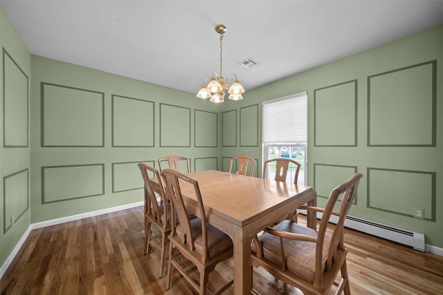 7 Center Cir, Florida, NY 10921 - dining room with baseboard heating, a decorative wall, a chandelier, dark wood-type flooring, and visible vents
