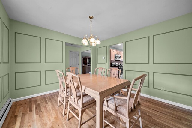 7 Center Cir, Florida, NY 10921 - dining area featuring a baseboard heating unit, light wood finished floors, baseboards, and a notable chandelier