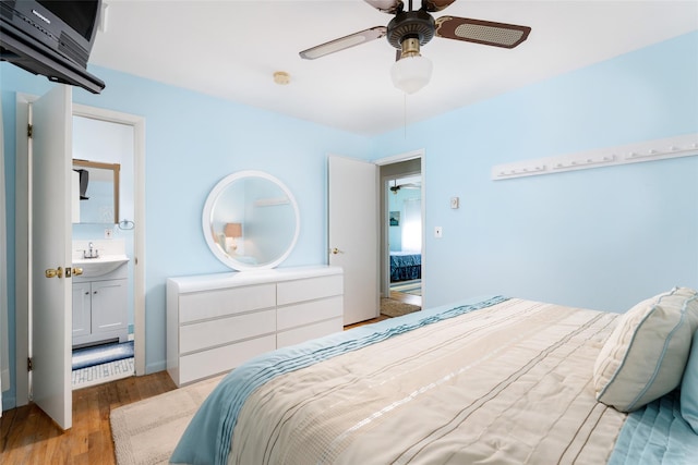 bedroom with ceiling fan, light wood-style floors, and a sink