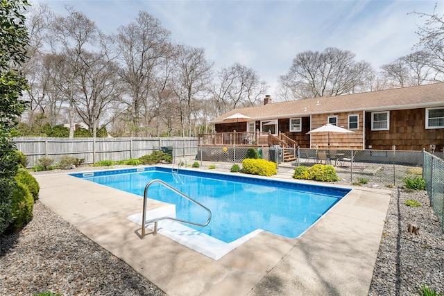view of swimming pool with a fenced in pool, stairway, a deck, and a fenced backyard