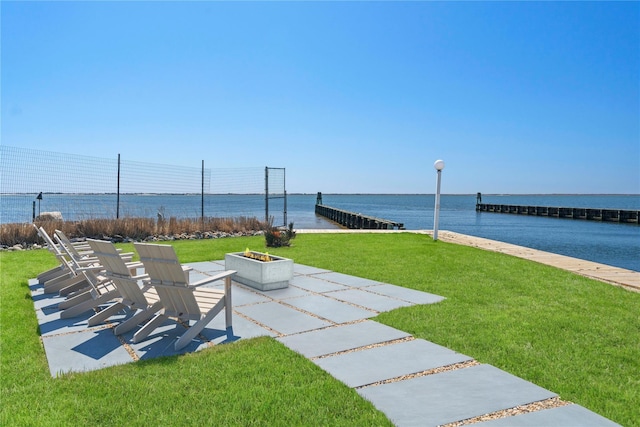 view of yard with a patio, a fire pit, and a water view