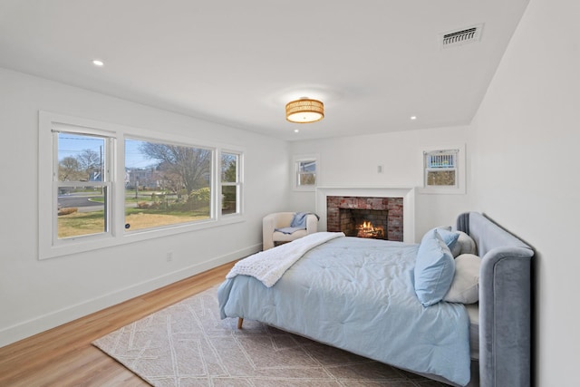 bedroom with wood finished floors, baseboards, visible vents, and recessed lighting