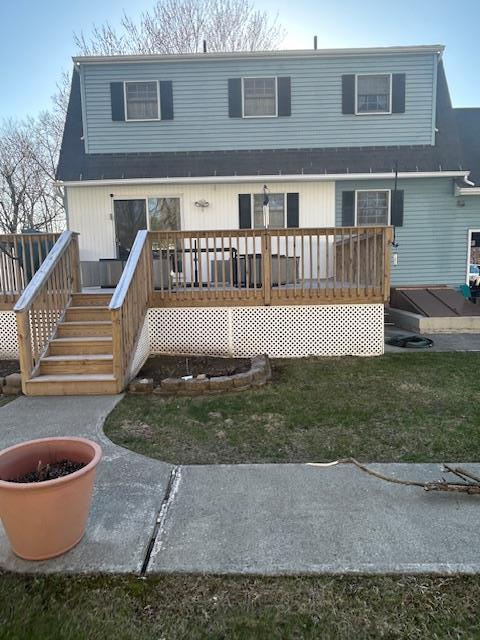 rear view of property featuring a wooden deck