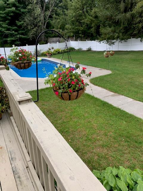 view of swimming pool featuring a yard, a fenced in pool, and a fenced backyard