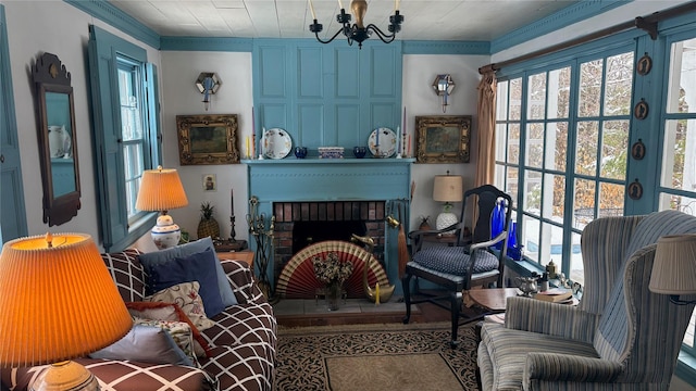 sitting room featuring a chandelier, a fireplace, and ornamental molding