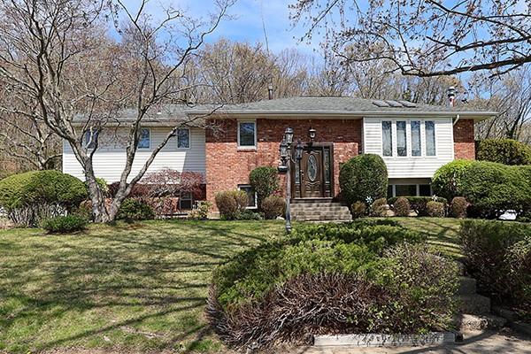 80 Lauren Ave, Dix Hills, NY 11746 - bi-level home with brick siding and a front lawn