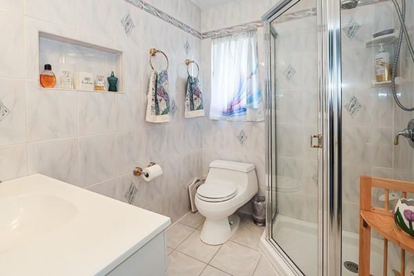 80 Lauren Ave, Dix Hills, NY 11746 - full bath with a shower stall, tile walls, tile patterned floors, toilet, and vanity