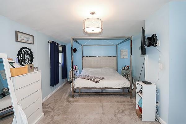 80 Lauren Ave, Dix Hills, NY 11746 - carpeted bedroom featuring baseboards