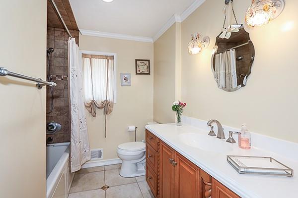 80 Lauren Ave, Dix Hills, NY 11746 - bathroom with toilet, vanity, crown molding, shower / tub combo with curtain, and tile patterned floors