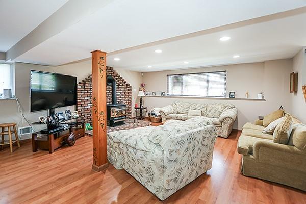 80 Lauren Ave, Dix Hills, NY 11746 - living area with a wood stove, wood finished floors, and recessed lighting