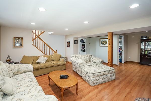 80 Lauren Ave, Dix Hills, NY 11746 - living area with stairway, light wood-style floors, recessed lighting, and baseboards