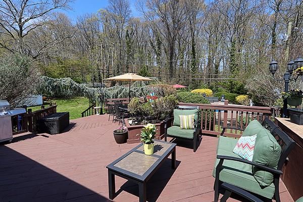 80 Lauren Ave, Dix Hills, NY 11746 - wooden terrace with an outdoor living space
