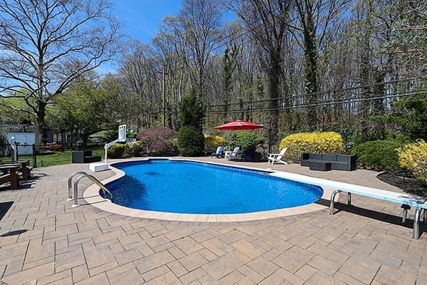 80 Lauren Ave, Dix Hills, NY 11746 - outdoor pool with a patio, a diving board, and fence