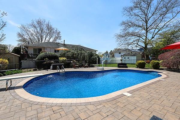 80 Lauren Ave, Dix Hills, NY 11746 - view of pool with a patio area, fence, a storage shed, a residential view, and an outbuilding
