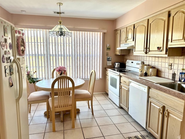 kitchen with a sink, white appliances, a chandelier, under cabinet range hood, and backsplash