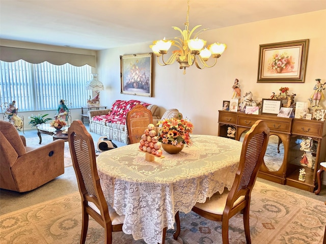 dining room with an inviting chandelier and light carpet