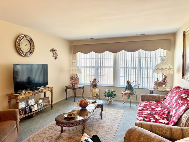 living room with visible vents, baseboards, and carpet