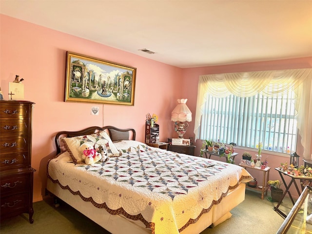 carpeted bedroom featuring visible vents