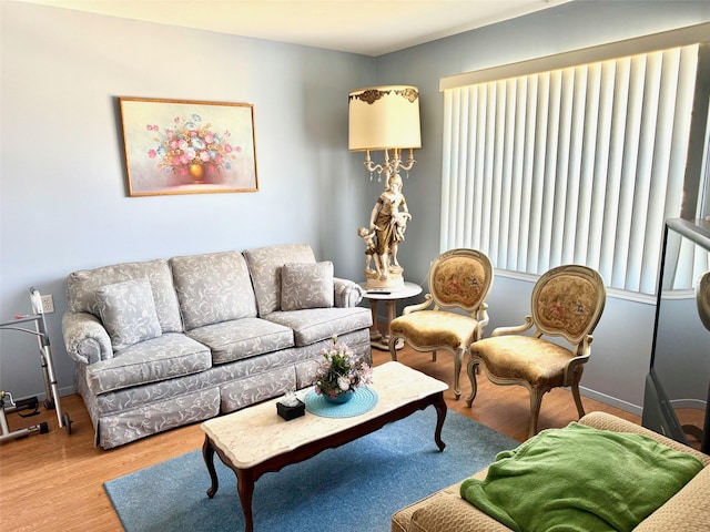 living area with baseboards and wood finished floors
