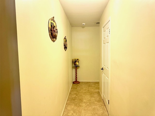 corridor featuring visible vents and baseboards