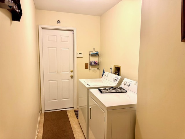 laundry room with independent washer and dryer, laundry area, and baseboards