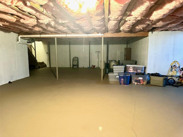 unfinished below grade area featuring stairway
