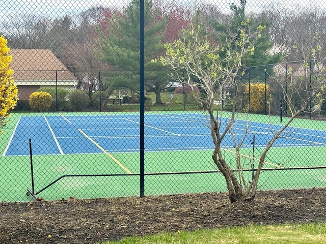 view of tennis court with fence