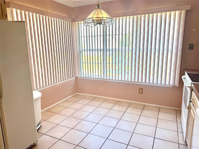 11 Theodore Dr, Coram, NY 11727 - unfurnished dining area with light tile patterned flooring and a chandelier