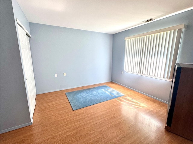 11 Theodore Dr, Coram, NY 11727 - unfurnished bedroom featuring wood finished floors and a closet