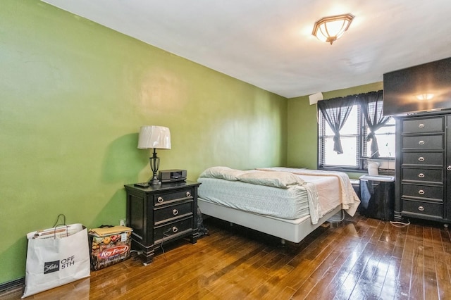 bedroom with dark wood-type flooring