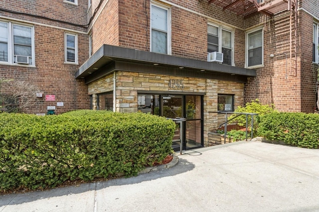 entrance to property with brick siding and stone siding
